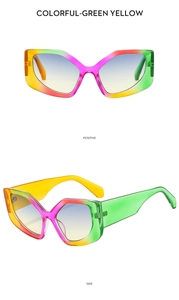 Close-up of oversized geometric sunglasses with multi-color gradient frames and blue lenses