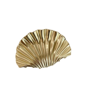 Elegant gold metallic scallop shell hair claw clip with glossy ribbed texture for women