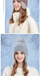Detailed view of warm winter knit earflap hats with faux fur pom-poms in snowy outdoor setting