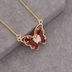 Gold 18K butterfly necklace with large red gemstones and clear zircon accents