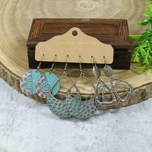 Detailed view of bohemian turquoise drop earrings set with vintage bronze metal finish