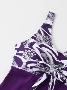 Detailed view of dark purple tankini swimwear with geometric prints and front bow tie knot