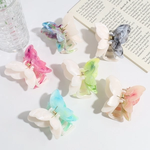 Detail shot of six colorful gradient butterfly hair claws in various elegant shades