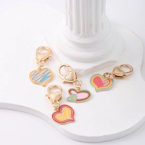 Detailed view of colorful heart-shaped alloy enamel charms with golden lobster clasps