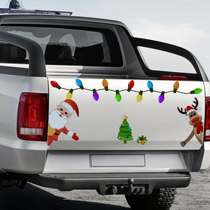 Christmas magnetic car stickers featuring Santa and reindeer on a white truck tailgate
