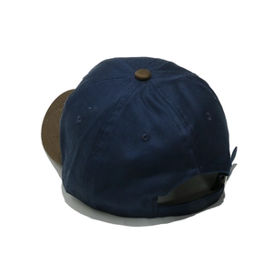 Rear view of blue and brown baseball cap featuring adjustable strap on white background