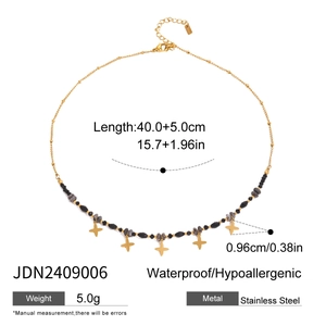 Stainless steel beaded necklace with gold star pendants on a minimal white background