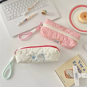 Quilted cartoon pencil case detail showing soft heart stitching and cute bunny embroidery