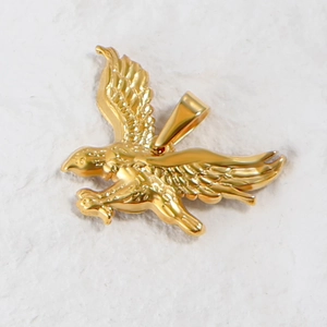 Macro shot of 24K gold plated eagle animal pendant with detailed metallic texture