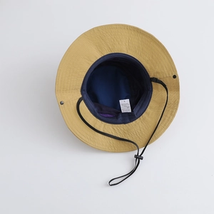 Detail of outdoor bucket hat showing breathable mesh lining and adjustable wind cord