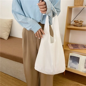 Close-up of white fabric tote bag with textured material in a cozy home setting