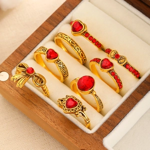Vintage gold ring set with red gemstones featuring heart and bow-knot retro designs