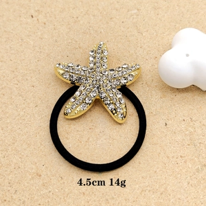 Elegant gold starfish hair tie with sparkling rhinestones and black elastic band
