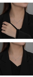 Macro detail of silver sterling love lock and key pendants on a minimalist choker chain