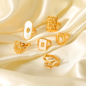 Detailed set of 6 gold rings featuring geometric patterns, white pearl inlays and crystals