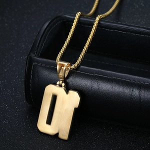 Close-up of gold-plated number 01 pendant on a thick round chain over black leather