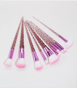 Detailed close-up of 10-piece unicorn makeup brush set with pink glitter handles
