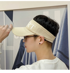 Side view of model wearing a beige knitted sun hat with embroidered RT sports lettering