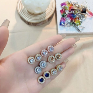 Starry round stud earrings with shimmering zircons and paved crystals in various metal finishes
