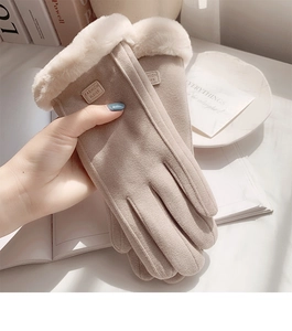 Detail of khaki suede winter gloves with thick faux fur trim and fashion leather label