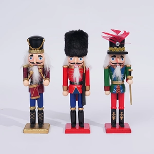 Detail of three 20cm wooden nutcracker soldiers with glitter and fur decorations