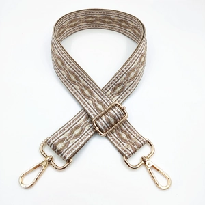 Detail of adjustable geometric jacquard bag strap with gold metal lobster clasps