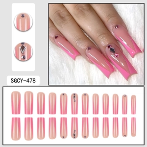 Pink French ombre press-on nails with rhinestone accents in long coffin shape