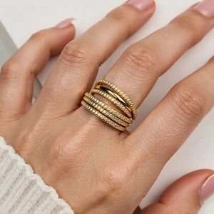 Multi-layer gold-plated 18K ring with micro-pave zircons shown on hand in a close-up view