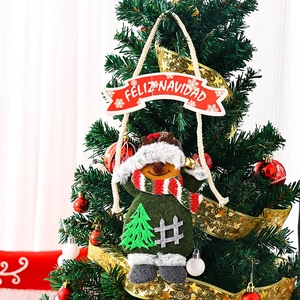 Detail of plush reindeer ornament with Feliz Navidad banner on a decorated Xmas tree