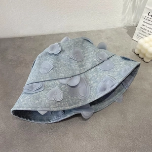 Light blue denim bucket hat with 3D heart patches, minimalist and stylish summer design