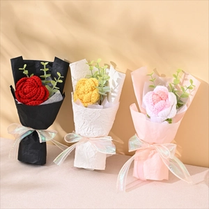Three handmade knitted flower bouquets in red, yellow and pink with elegant gift wrapping