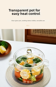 Close-up of heat-resistant glass pot with fresh vegetables on a woven placemat