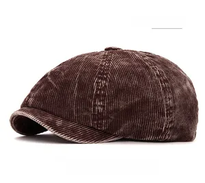 Close-up detail of dark coffee corduroy texture on a newsboy style baker boy cap