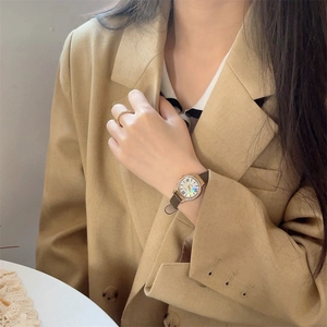 Elegant women's watch with brown leather strap, gold diamond dial and shell face