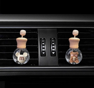 Car air vent perfume clips featuring cartoon bear and Mickey shaped glass bottles
