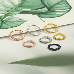 Macro detail of cubic zirconia inlaid nose rings in gold, silver, rose gold and black