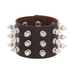 Detailed view of dark brown leather punk bracelet with three rows of silver metal spikes