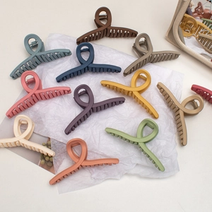 Flat lay view of large matte hair claws in various Morandi and Macaroon colors