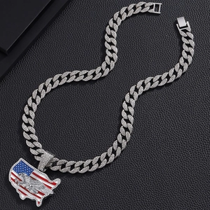 Macro view of iced-out USA map pendant with eagle motif on thick silver cuban chain