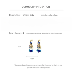 Detailed size specifications and weight info for vintage peacock rhinestone earrings