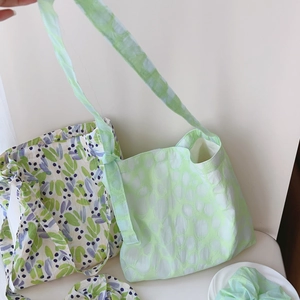 Detailed set of floral printed cotton tote bag and matching scrunchie with leaf patterns