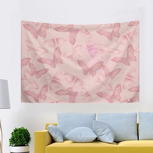 Pink butterfly tapestry for bedroom wall decor hanging above a yellow sofa and green plant