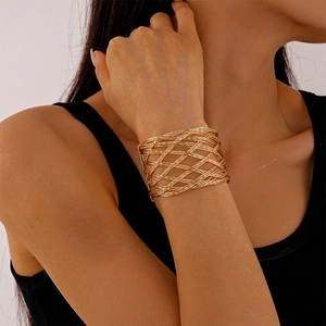 Minimalist gold woven mesh cuff bracelet with hollow design on female model wrist