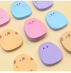 Close-up of cute cartoon animal sticky notes in various colors on a beige background