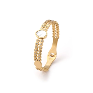 Close-up of gold stainless steel bangle featuring white mother of pearl and cubic zirconia
