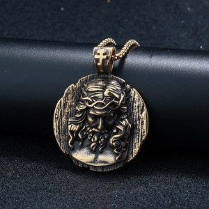 Detailed macro view of golden Jesus crown of thorns relief on a round stainless steel medal