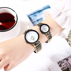 Elegant pair of ORLANDO quartz watches with black and gold metal bands on wrist