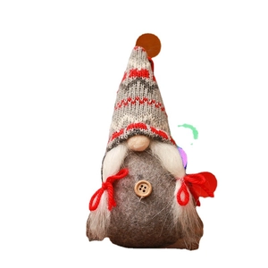 Handmade Christmas gnome with grey knit hat, white braids, and a wooden button detail