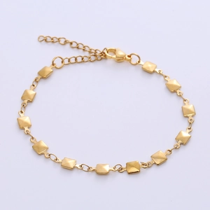 Detailed macro view of golden link bracelet with lobster clasp and adjustable chain