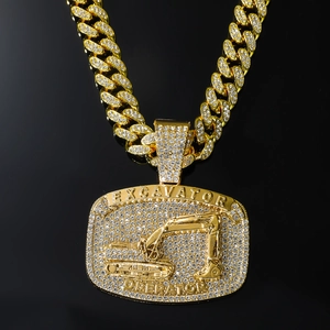 Macro shot of gold-tone iced out excavator operator pendant with Cuban link chain detail